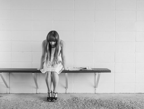 worried girl on bench, black & white photo